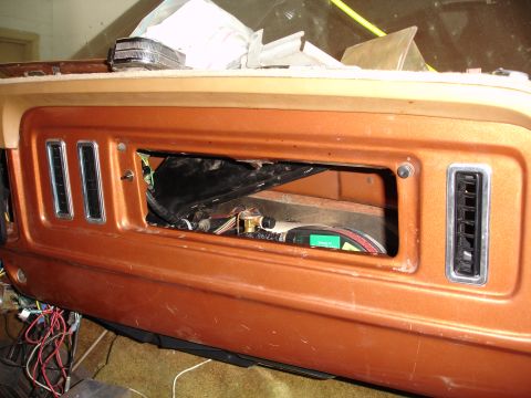 1977 Ford F-150 - The interior of a 1977 Ford F-150 shows its dashboard with wiring exposed in the radio opening.