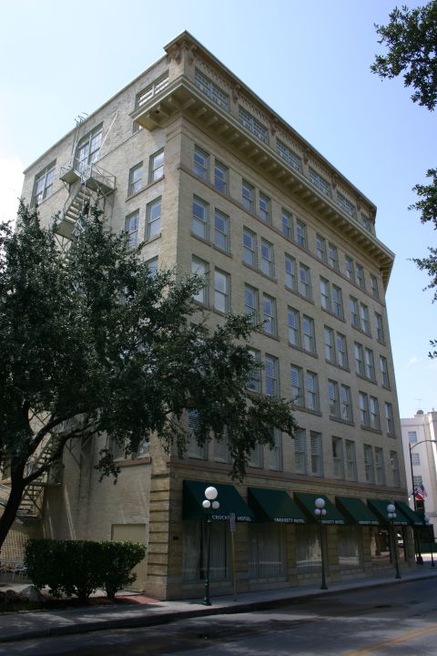1997 Ford Probe - A historic hotel building with multiple floors and windows stands on a city street.