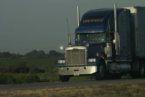 1997 Ford Probe - A blue semi-truck with 'WERNER' on the side is traveling down the road.