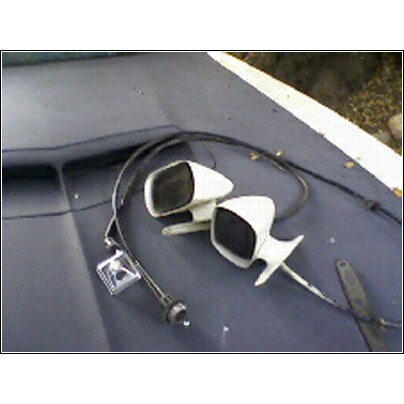 1973 Ford Ranchero - Two white side mirrors and an antenna base are visible on a dark surface.
