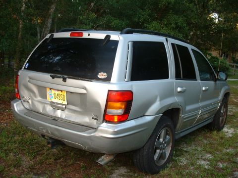 1995 Ford Bronco - This Jeep Grand Cherokee shows extensive damage to its rear end, including the tailgate and bumper.