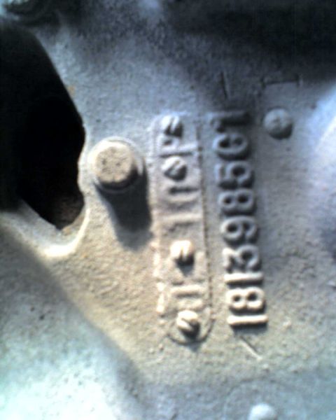 1965 Ford Mustang - This image shows stamped casting numbers on a metal component, not a 1965 Ford Mustang.
