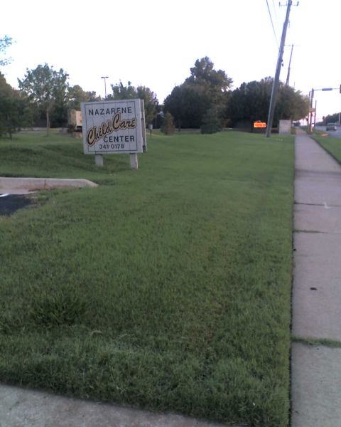 1965 Ford Mustang - A sign for a child care center is visible on a grassy lawn next to a sidewalk.