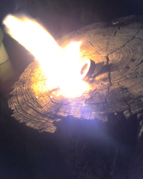 1965 Ford Mustang - A torch flame is burning on a log, with a watermark for Supermotors.net visible.
