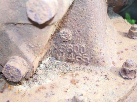 1979 Ford F-150 - A close-up view of a heavily rusted metal component with visible stamped identification numbers.