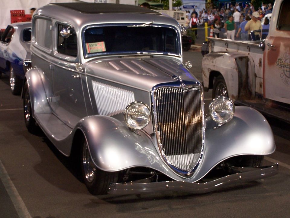 Silver sedan delivery with a prominent grille and sun roof