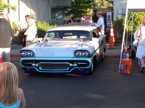 1990 Ford Bronco - A heavily customized 1958 station wagon with a unique front end and colorful side stripes is displayed outdoors.
