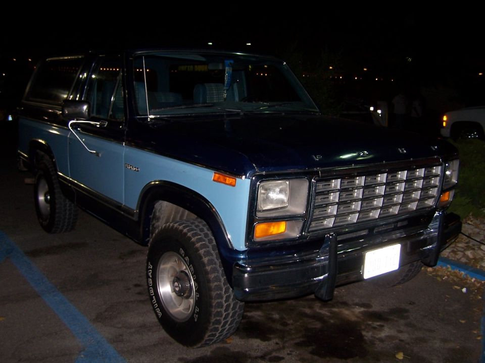 Two-tone blue Ford Bronco with chrome grille and bumper