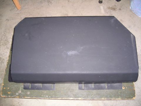 2003 Jeep TJ - A black metal skid plate is shown from above, resting on a wooden surface.