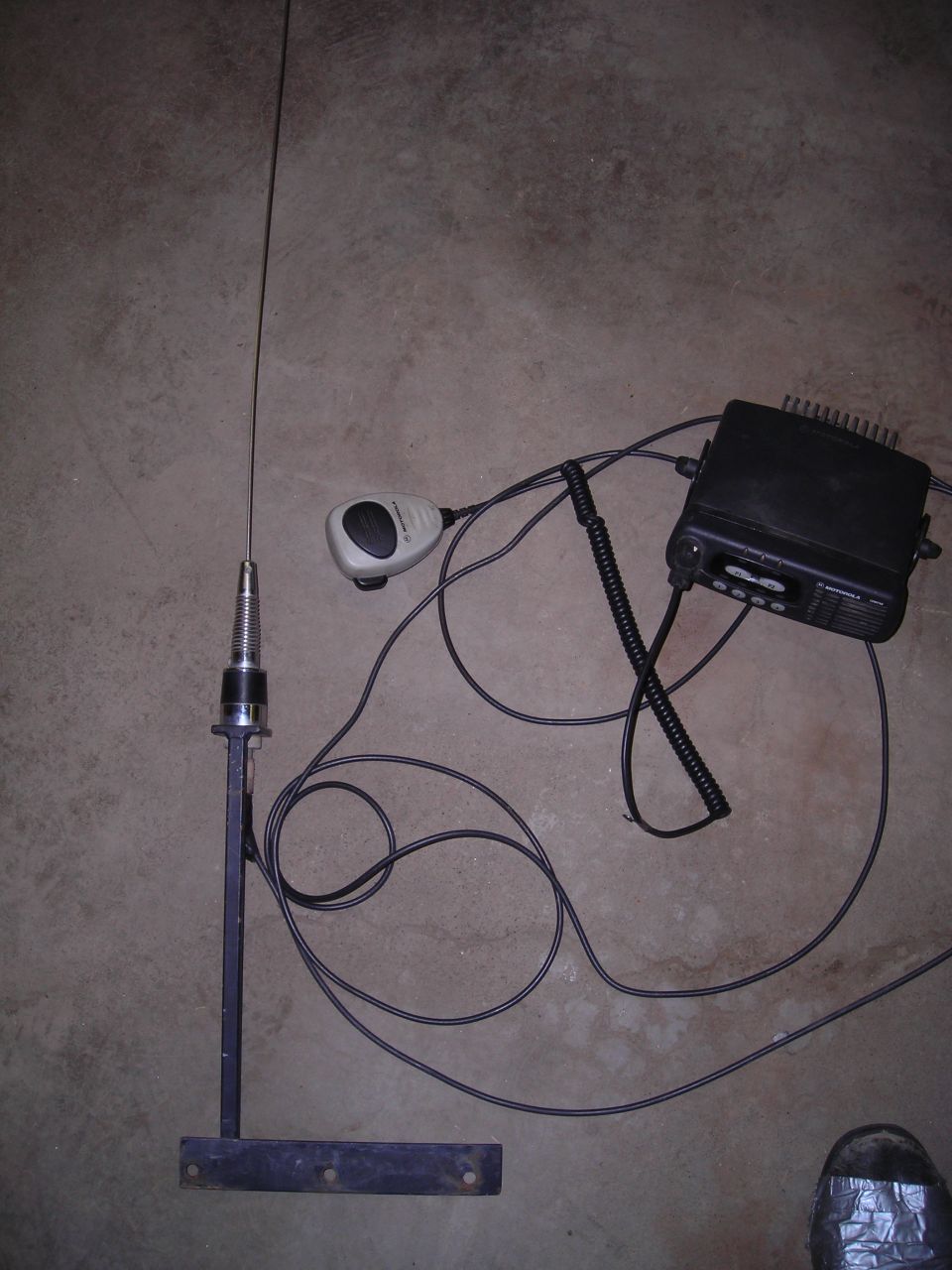 CB radio and antenna with microphone on concrete floor