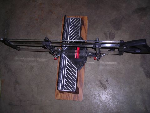 2003 Jeep TJ - A miter saw is shown mounted on a wooden base against a concrete floor.