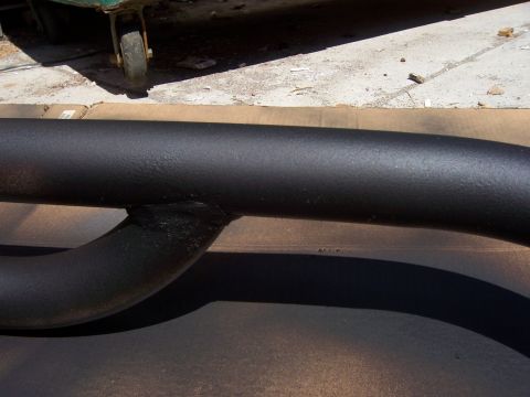 1991 Ford Bronco - A close-up view of a black metal tube, possibly a vehicle accessory, with visible welds.
