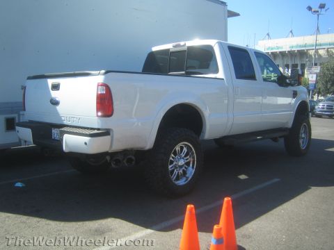 1968 Ford Mustang - White Ford F-250 Super Duty pickup truck parked outdoors with traffic cones nearby.