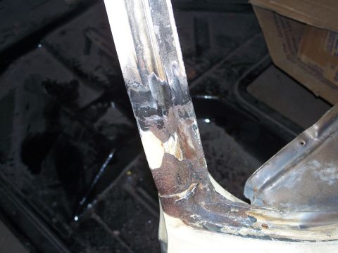 1979 Ford F-150 - Close-up view of a heavily rusted metal structural component, possibly from a vehicle's interior or body.