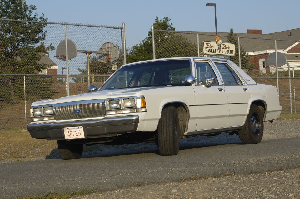 1991 Ford Crown Victoria LTD parked near a basketball court