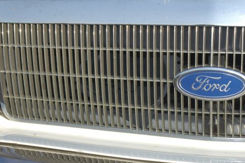 1991 Ford Crown Victoria LTD - The blue Ford oval emblem is centered on a vertical bar grille.