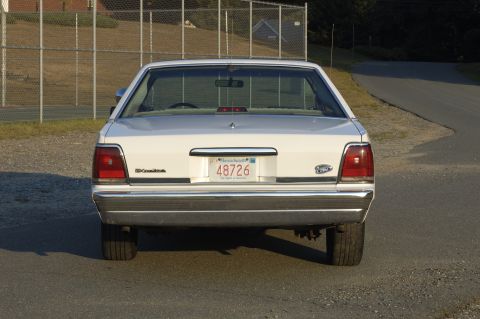 1991 Ford Crown Victoria LTD - Rear view of a white 1991 Ford Crown Victoria LTD sedan parked outdoors.