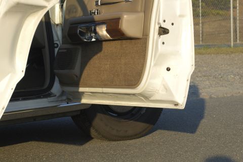 1991 Ford Crown Victoria LTD - Interior view of an open car door, revealing the door panel and a tire.