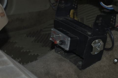 1991 Ford Crown Victoria LTD - An aftermarket control box with various switches and a knob is visible on the floor of a vehicle's interior.