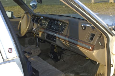 1991 Ford Crown Victoria LTD - The interior of a 1991 Ford Crown Victoria LTD, its dashboard, steering wheel, and seating.