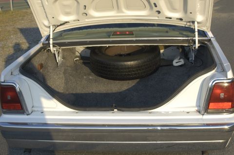 1991 Ford Crown Victoria LTD - Trunk interior of a 1991 Ford Crown Victoria LTD, complete with spare tire.