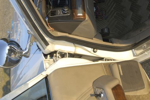 1991 Ford Crown Victoria LTD - A view of the interior of a white vehicle, focusing on the dashboard and door panel details.