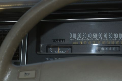 1991 Ford Crown Victoria LTD - Close-up of a car's dashboard gauges and gear selector.