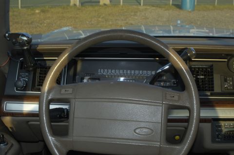 1991 Ford Crown Victoria LTD - The interior of a 1991 Ford Crown Victoria LTD shows the dashboard, steering wheel, and center console.