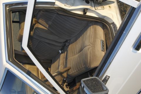 1991 Ford Crown Victoria LTD - The interior of a car is visible, showing the front seats and dashboard area.
