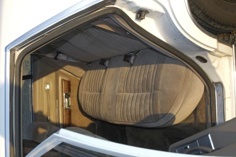 1991 Ford Crown Victoria LTD - Interior view of a car's rear seat and door frame, with a tire visible in the background.