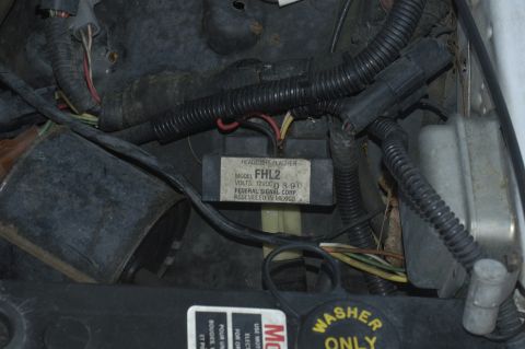 1991 Ford Crown Victoria LTD - Close-up of a headlight flasher module, part of a vehicle's electrical system.