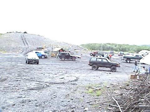 1978 Ford Bronco - Multiple SUVs and trucks are gathered in an outdoor area, possibly for an event.