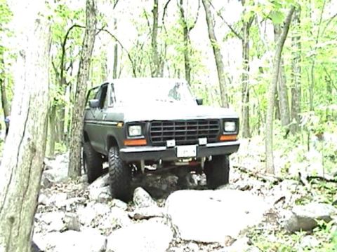 1978 Ford Bronco - This 1978 Ford Bronco is navigating a challenging rocky path through the woods.