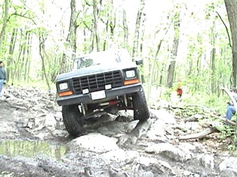 1978 Ford Bronco - This vehicle is navigating a challenging rocky path in a wooded area.