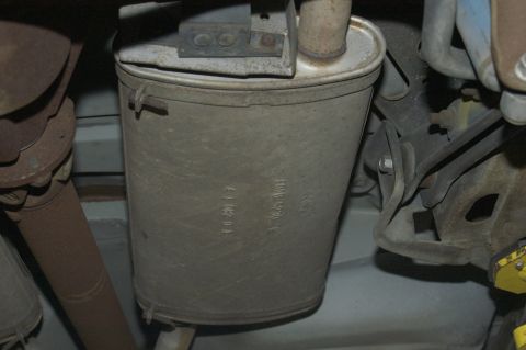 1991 Ford Crown Victoria LTD - Close-up view of a vehicle's exhaust muffler, showing stamped Ford branding and part numbers.