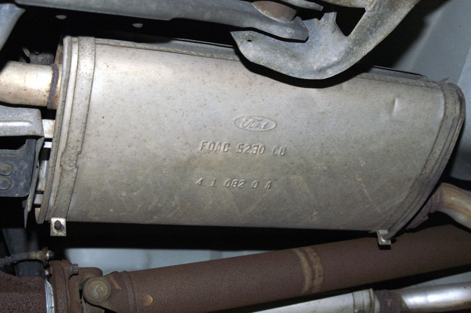Ford exhaust muffler with part numbers FOAC 5230 C8 and 41 082 0 A stamped on it