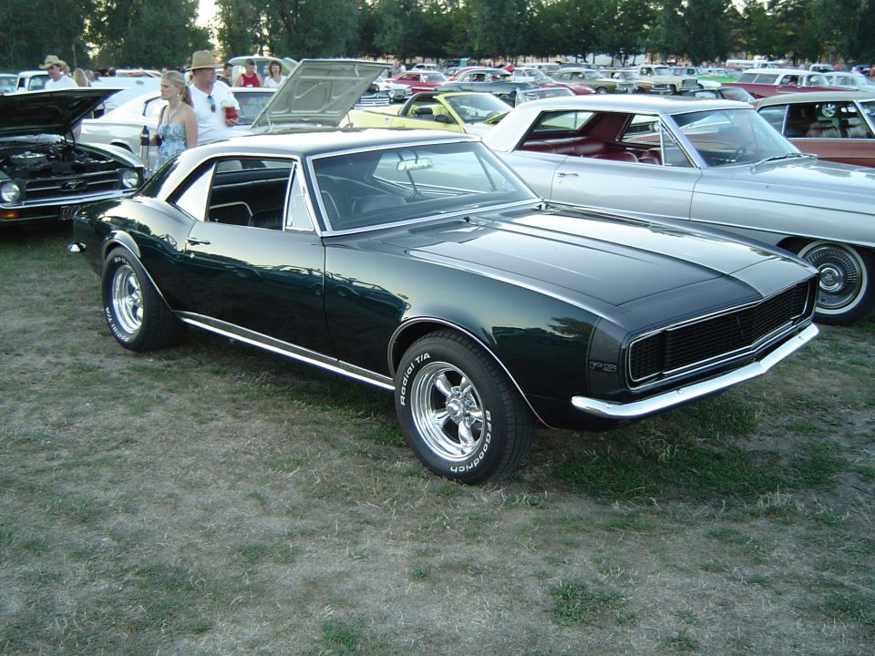 Dark green coupe with chrome trim and aftermarket wheels, 1967 model