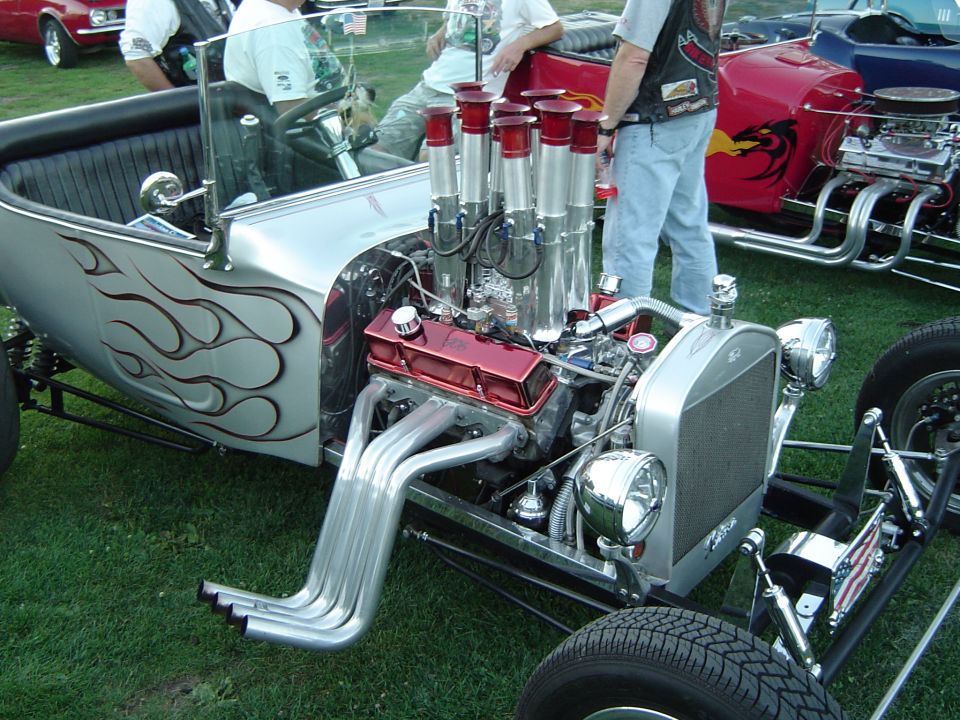 Silver flamed hot rod roadster with velocity stacks, red valve covers and zoomie headers