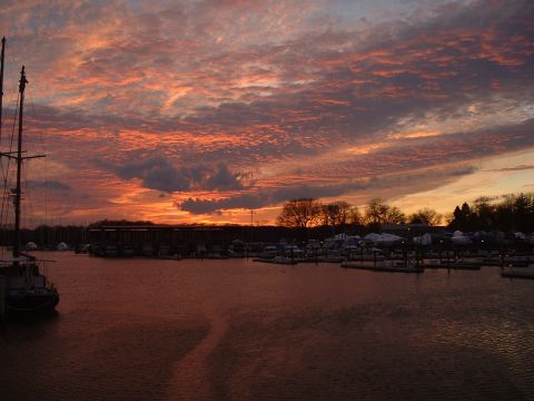 1994 Ford Bronco - Boats are docked in a marina during a vibrant sunset with colorful clouds.