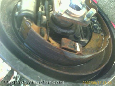 1987 Suzuki Samurai - Close-up view of a vehicle's brake drum and shoes, showing signs of rust and wear.