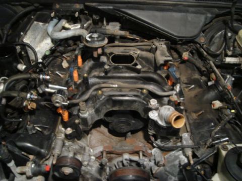 2000 Ford Crown Victoria - Close-up view of an engine bay with the intake manifold removed, revealing fuel injectors and associated wiring.