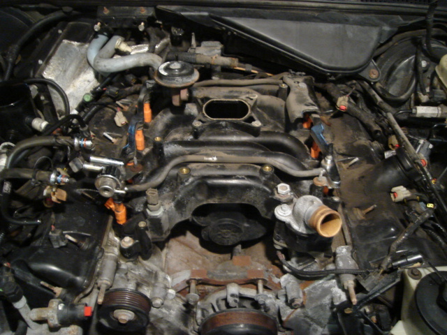 Engine bay with intake manifold removed, showing fuel injectors and wiring