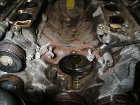 2000 Ford Crown Victoria - Close-up of an engine block showing a significant coolant leak. The intake manifold area appears to be the source.