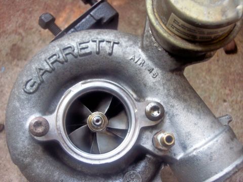 1994 Ford Probe - Close-up of a Garrett turbocharger, identified by the 'GARRETT' casting and 'AIR 49' marking.