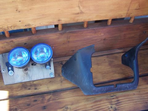 1994 Ford Probe - A pair of blue fog lights and a car bumper section are displayed on a wooden surface.