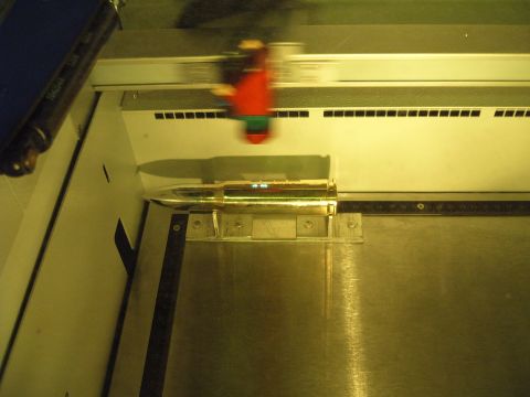 1988 Ford Bronco - A close-up view of a bullet casing being processed by industrial equipment.