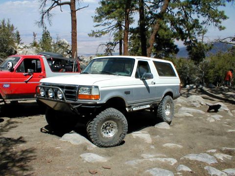 1996 Ford Bronco - This 1996 Ford Bronco features a custom front bumper and large off-road tires, ready for terrain.