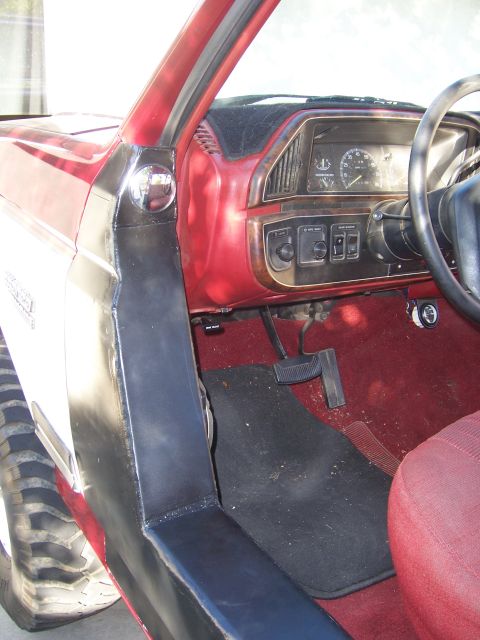 1991 Ford Bronco - Interior view of a 1991 Ford Bronco, highlighting the dashboard, pedals, and seating area.