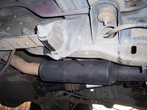 1991 Ford Bronco - A close-up view of the undercarriage reveals the exhaust pipe and suspension parts.