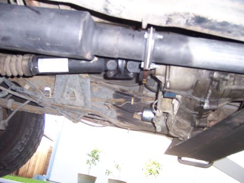 1991 Ford Bronco - Underside view of a vehicle's driveshaft and transmission components.